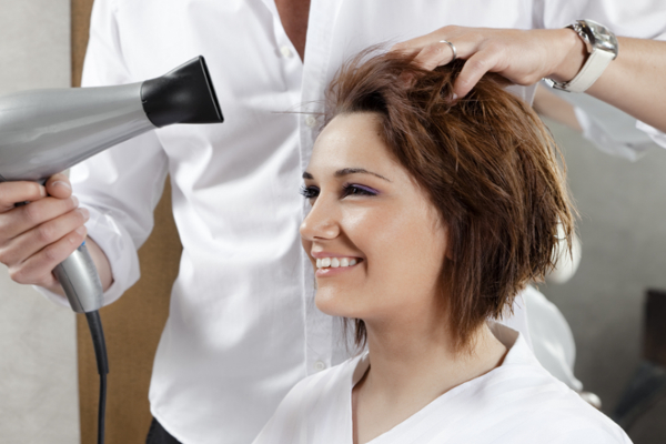 blow drying woman's hair