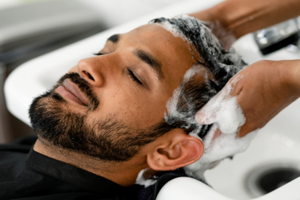 man getting hair washed