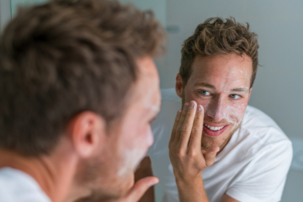 man washing face