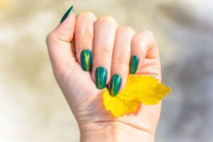 woman with green iridescent nails