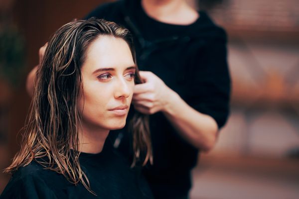 woman getting highlights in hair salon